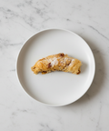 Almond Walnut Baklava Croissant - White Plate Marble Background